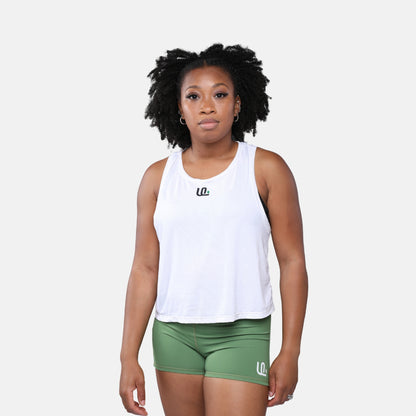 Woman wearing a white tank top and green shorts with Unsponsored Life logo 